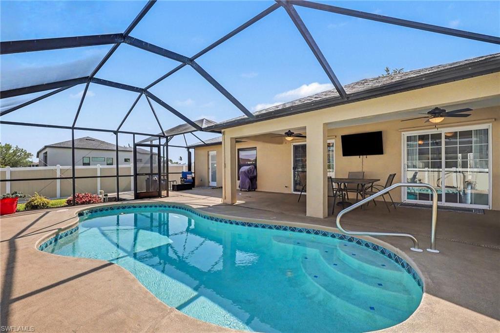 Image 4: View of pool featuring an outdoor dining space, patio surround, and a lanai