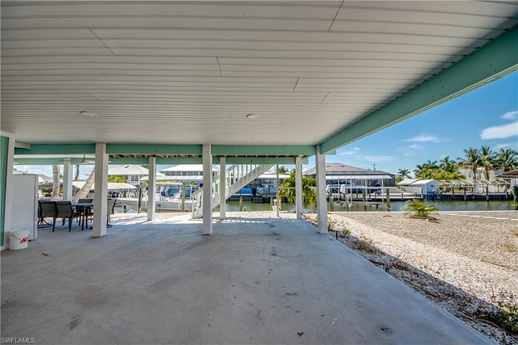 Image 3: Covered concrete patio with waterfront access