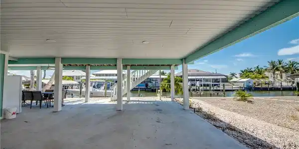 Image 3: Covered concrete patio with waterfront access