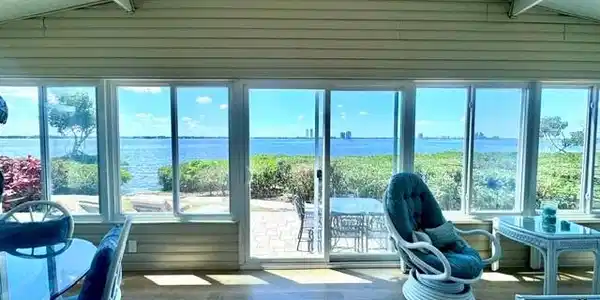 Image 3: Sunroom with sliding windows and River view