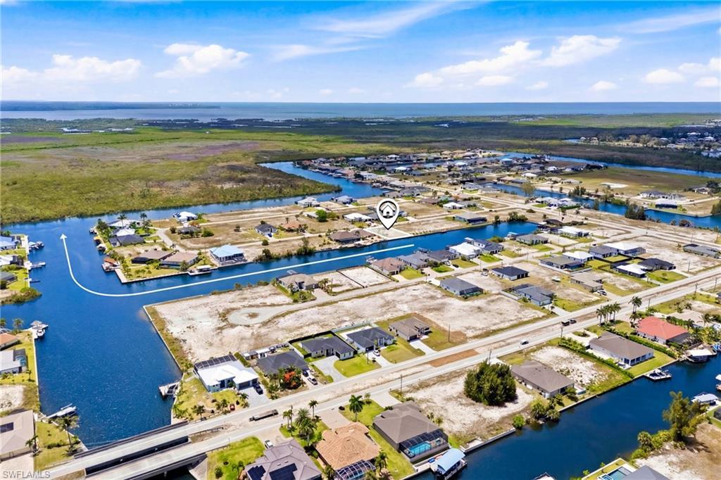 Image 4: Aerial perspective of a waterfront residential development with extensive canal access