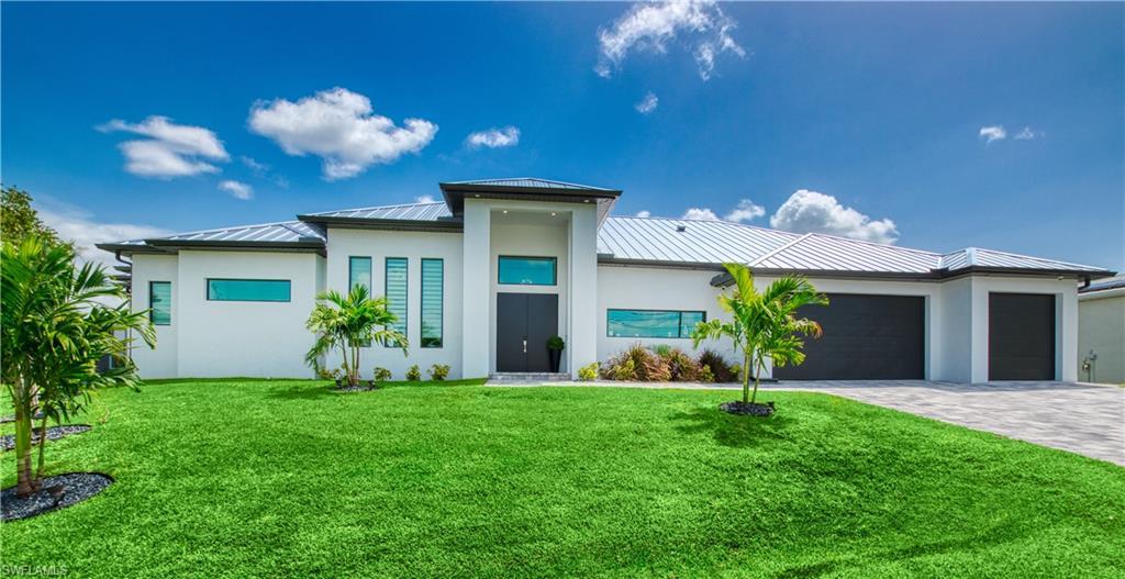 Image 1: Contemporary architecture featuring a white exterior, dark metal roof, and a meticulously maintained green lawn