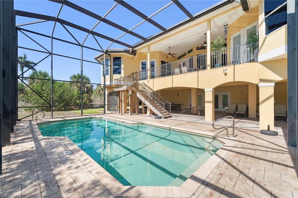 Image 3: Screened lanai featuring a swimming pool, extensive patio, and a covered ground-level entertainment area