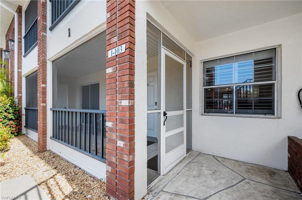 Image 2: Screened entry porch featuring a patterned concrete floor and a full-light screen door