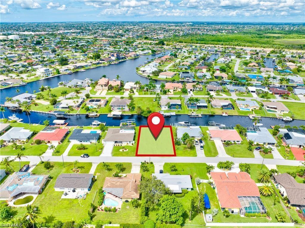 Image 2: Residential lot featuring green space and street frontage in a canal-front community