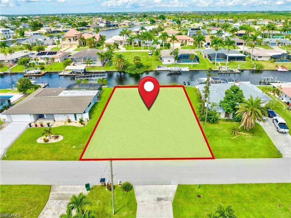 Image 4: Vacant land parcel featuring canal frontage with a clear boundary outline