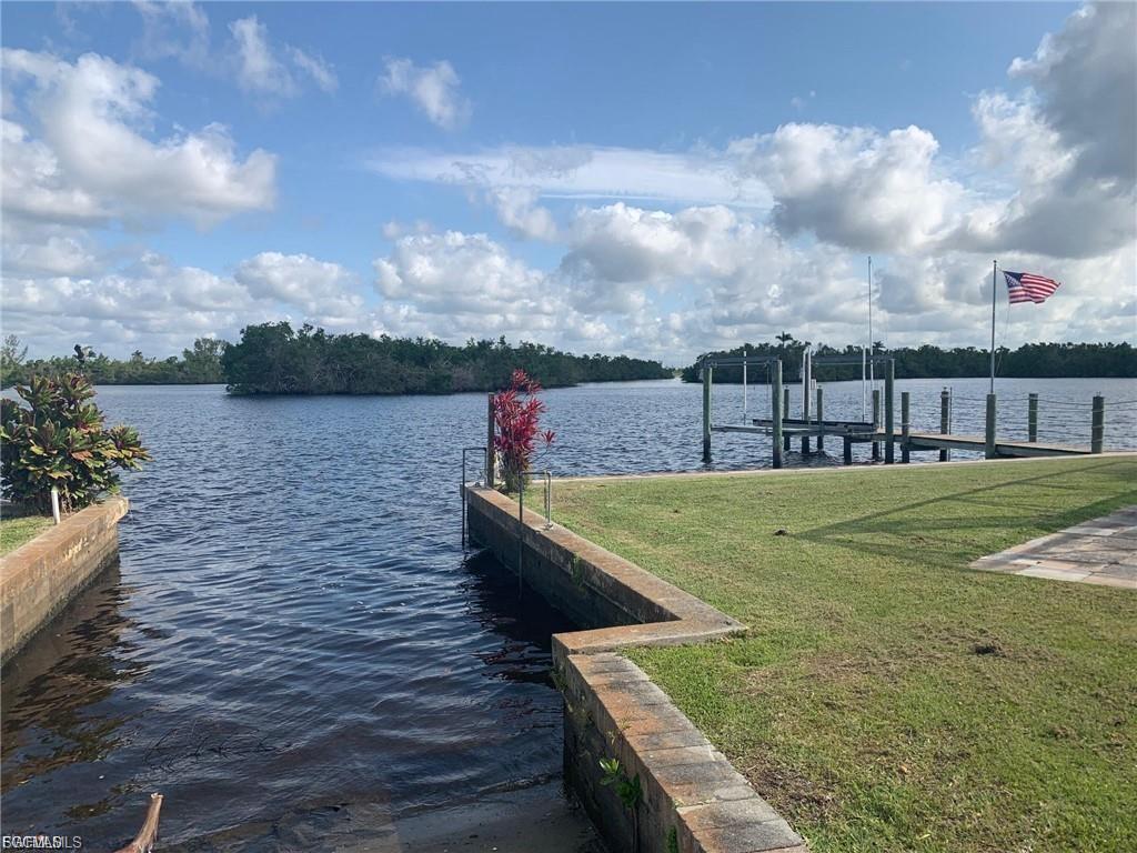 Image 2: Waterfront property featuring a private boat slip, an additional dock, and a manicured lawn