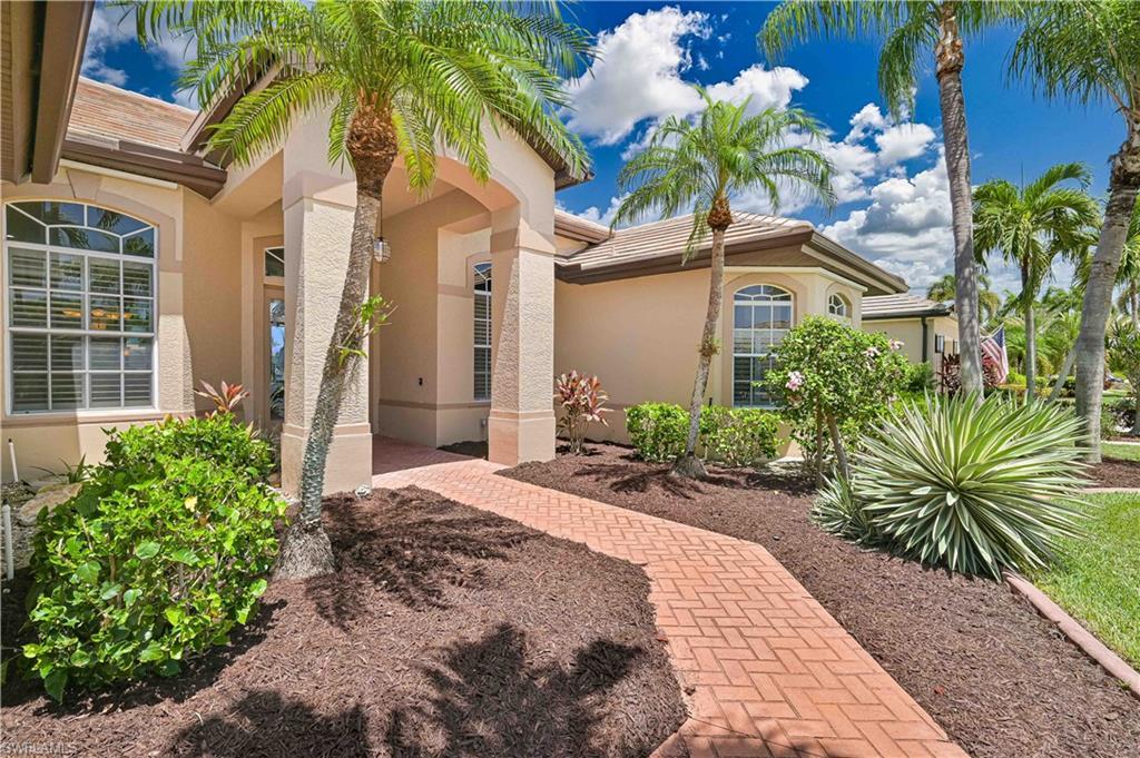 Image 3: Inviting stucco exterior with a tiled roof and arched windows