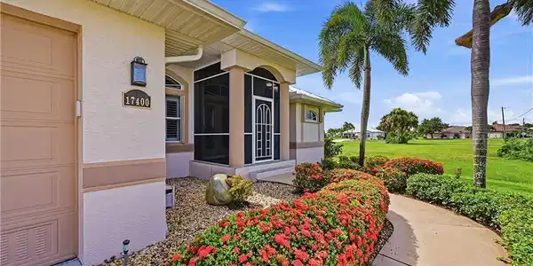 Image 3: Decorative hedge-trimmed sidewalk from driveway to front entrance