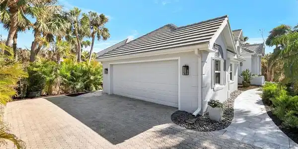 Image 4: View of property exterior featuring a garage