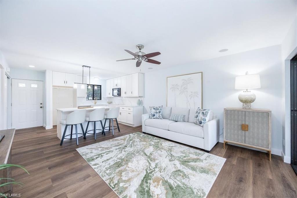 Image 2: Living room featuring dark wood-style floors, a ceiling fan, and recessed lighting