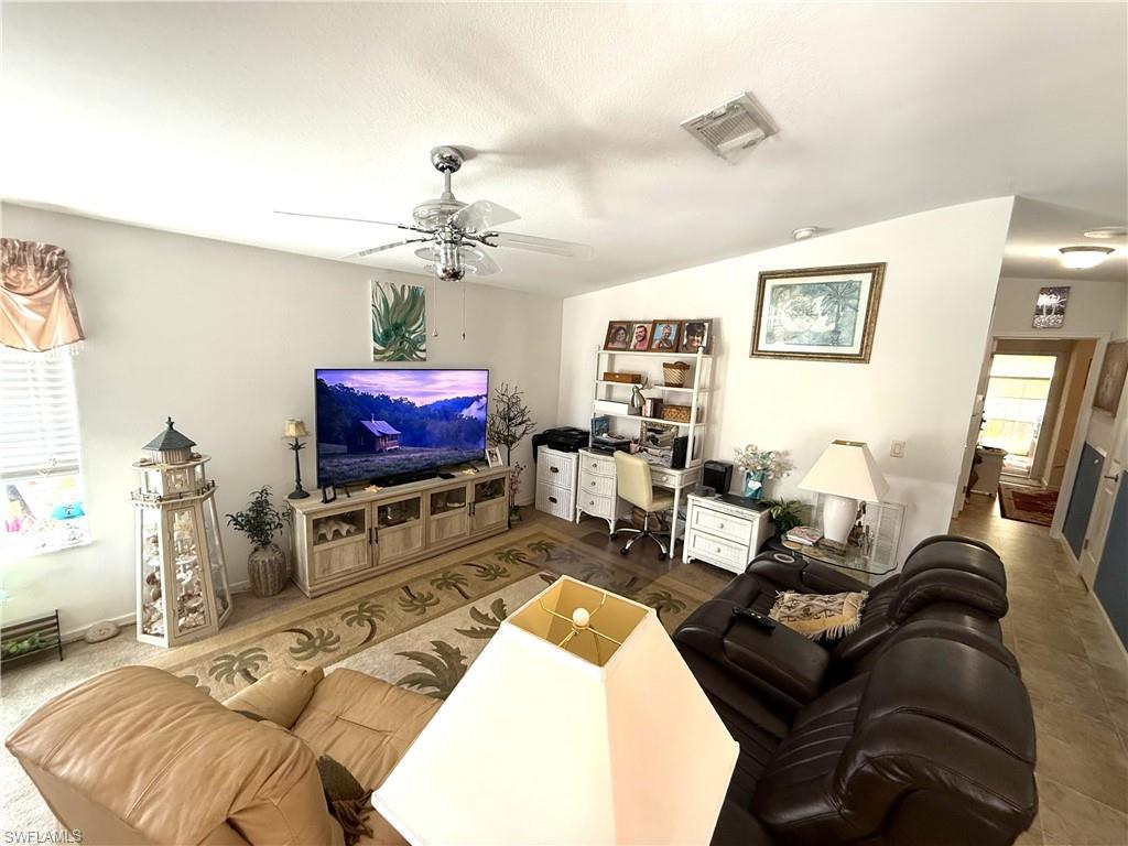 Image 2: Living room featuring ceiling fan, lofted ceiling, and an office area