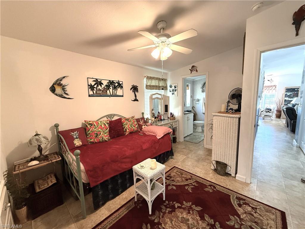 Image 4: Bedroom with a ceiling fan and ensuite bathroom