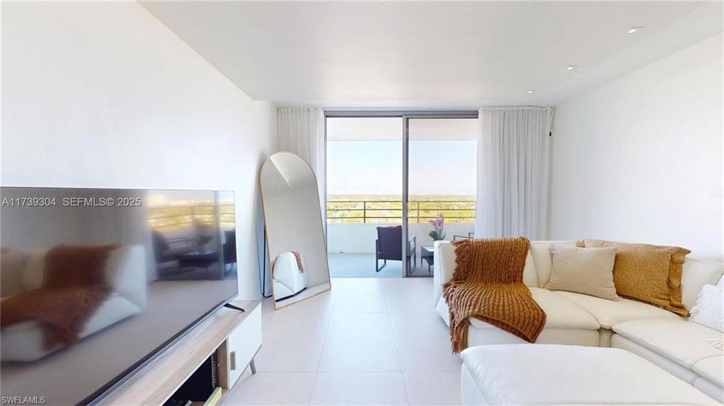 Image 4: Bright living area with white tile flooring and recessed lighting