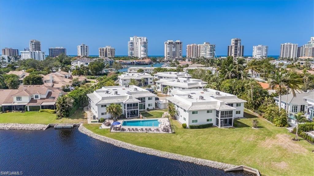 Image 1: Aerial View of Condo, Pool and Lake