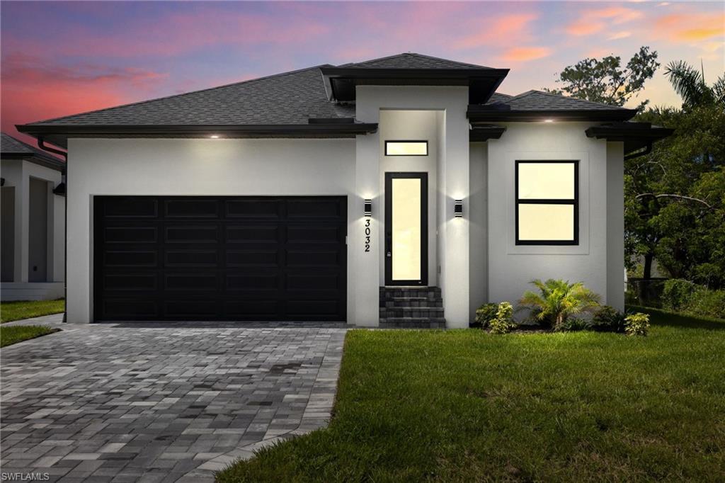 Image 2: Modern architecture with a white stucco facade and black trim accents