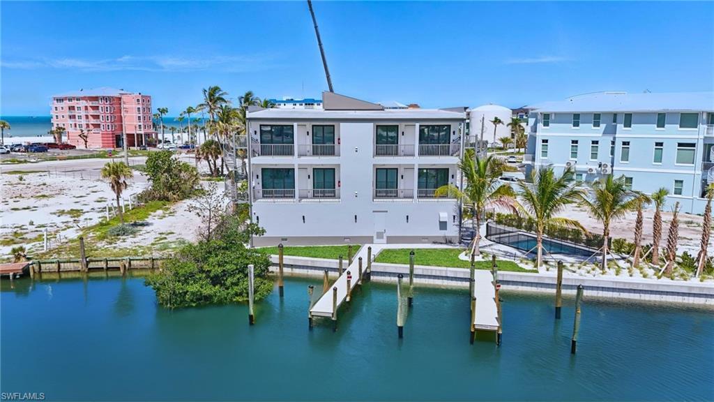 Image 1: Back of building featuring boat slips - VIRTUALLY EDITED