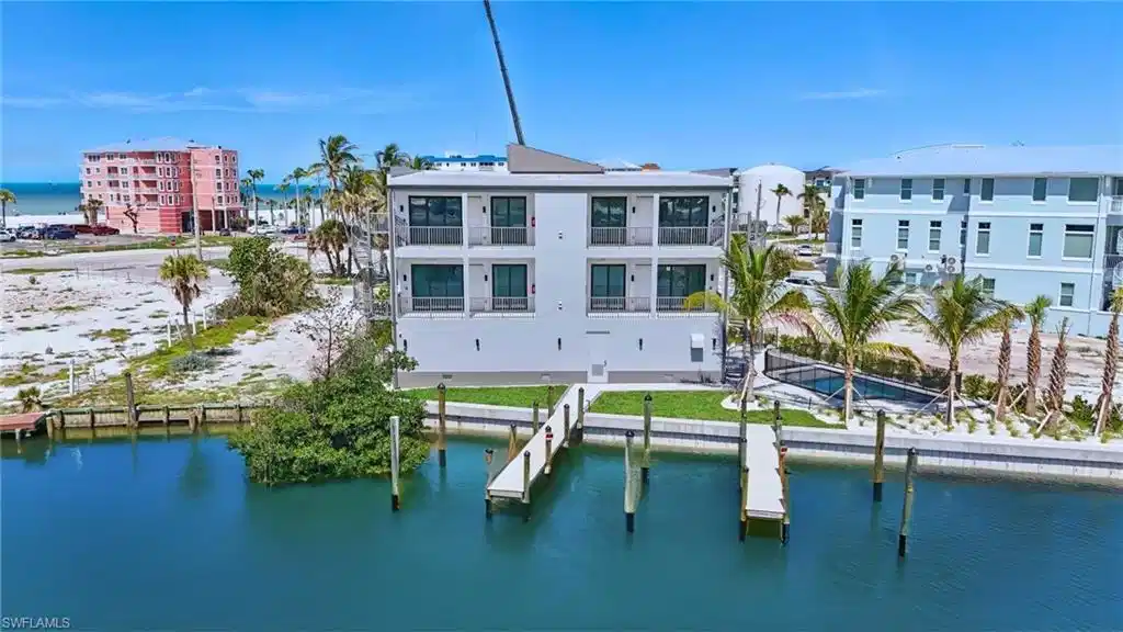 Image 1: Back of building featuring boat slips - VIRTUALLY EDITED