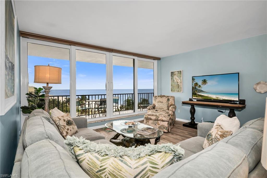 Image 2: Spacious living area designed to maximize natural light and Gulf views.
