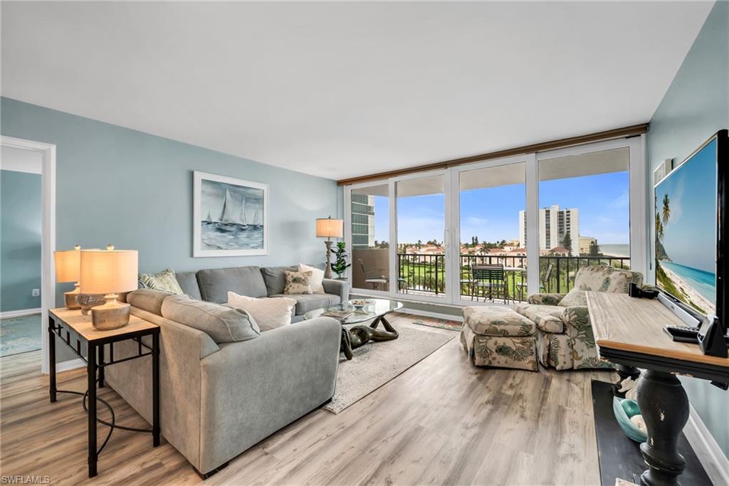 Image 3: Inviting gathering space with expansive windows framing beautiful water and beach views.