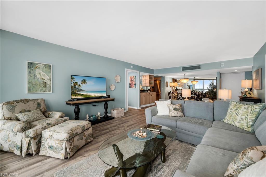 Image 4: Inviting living room offering a seamless blend of comfort and coastal charm.