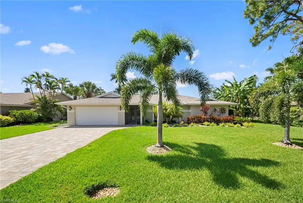Image 1: Exterior featuring a paved driveway, a two-car garage, and a lush front lawn