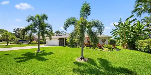 Image 2: Single-story residence featuring a two-car garage and a paved driveway