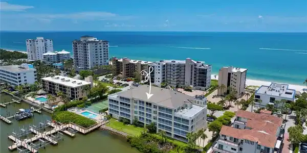 Image 4: Waterfront condominium property featuring multiple balconies, a swimming pool, and dedicated boat docks