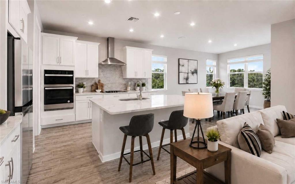 Image 3: Photo includes reality staging to showcase the possibility of the kitchen/dining/living room. Design services included with purchase!