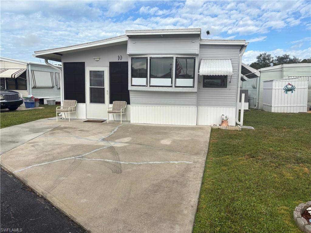 Image 1: FRONT of property with a yard
