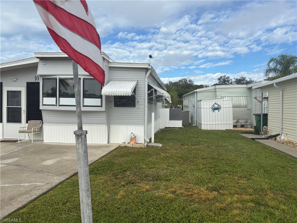 Image 2: View of side of property featuring a lawn