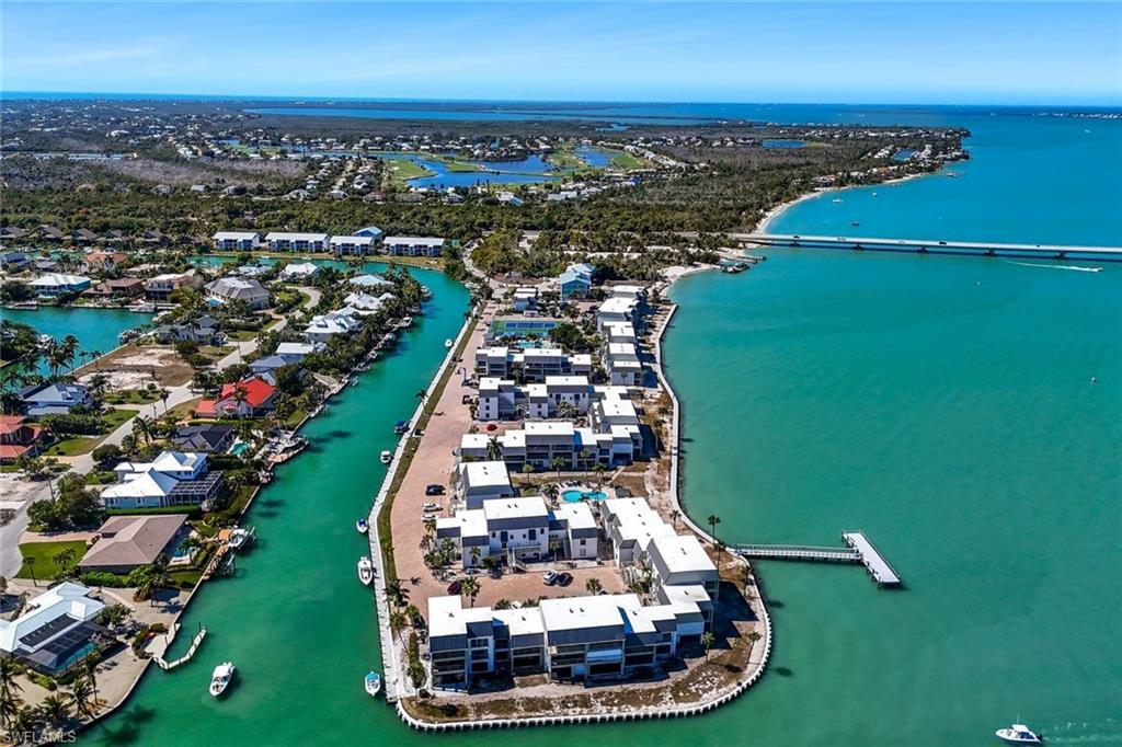 Image 1: Aerial view of property and surrounding area featuring a nearby body of water