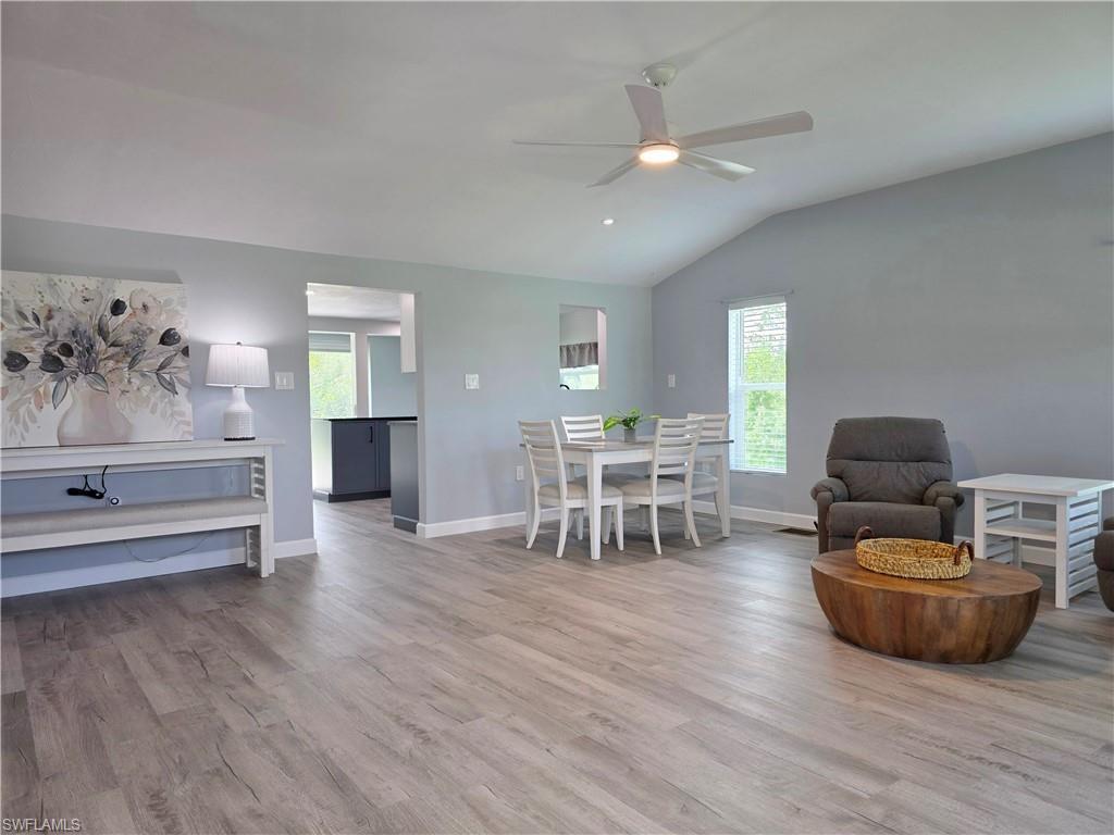 Image 4: Dining space with healthy amount of natural light, wood finished floors, a ceiling fan, and lofted ceiling