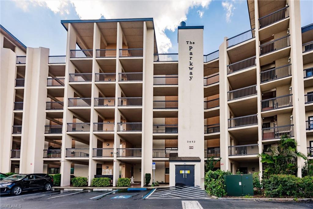 Image 1: View of apartment building / complex with uncovered parking