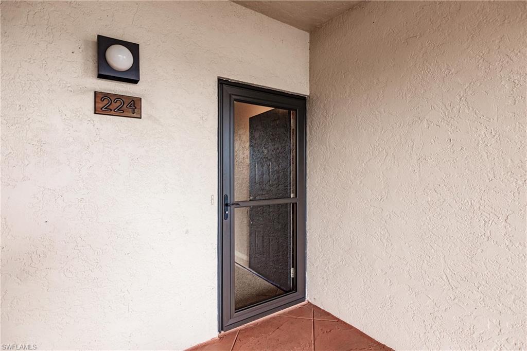Image 3: Doorway to property featuring stucco siding