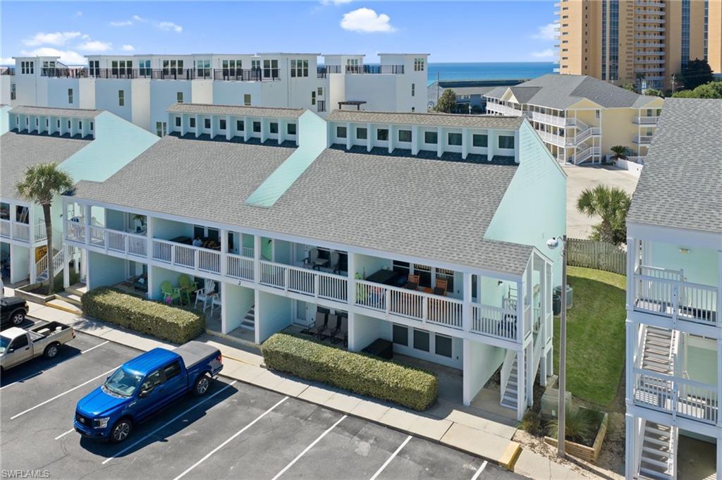 Image 4: Drone / aerial view of apartment complex / building and a nearby body of water