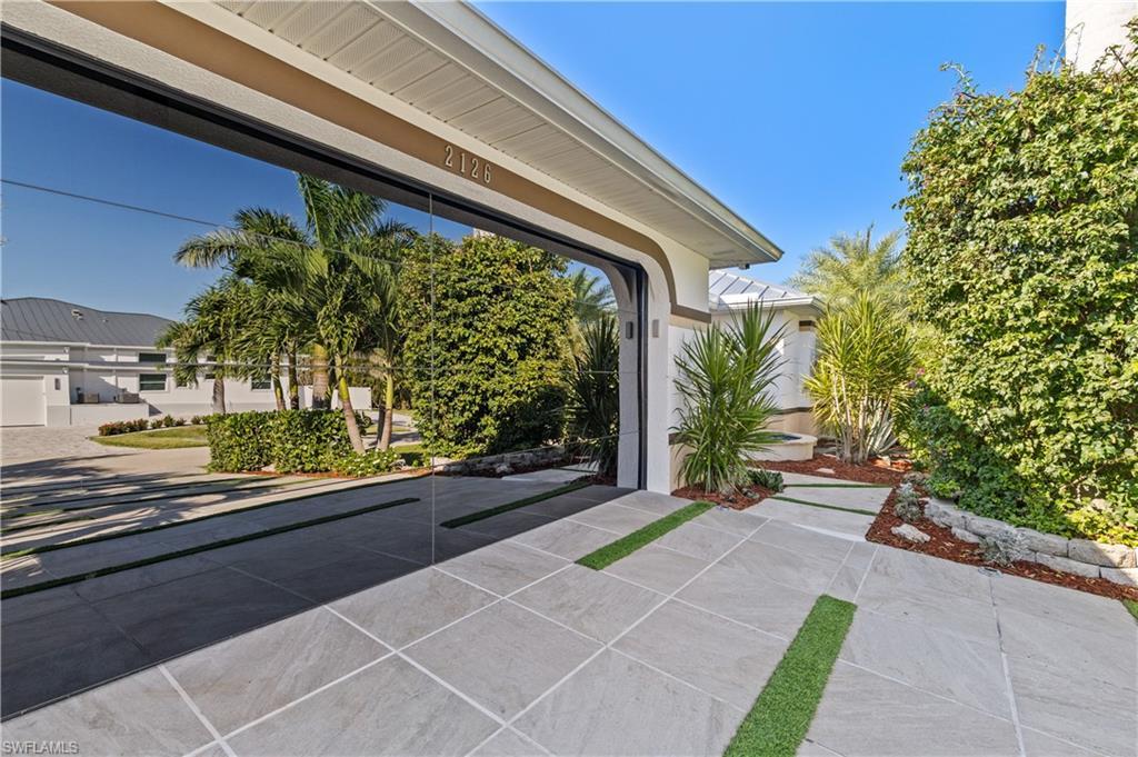 Image 2: View of entrance/glass garage door