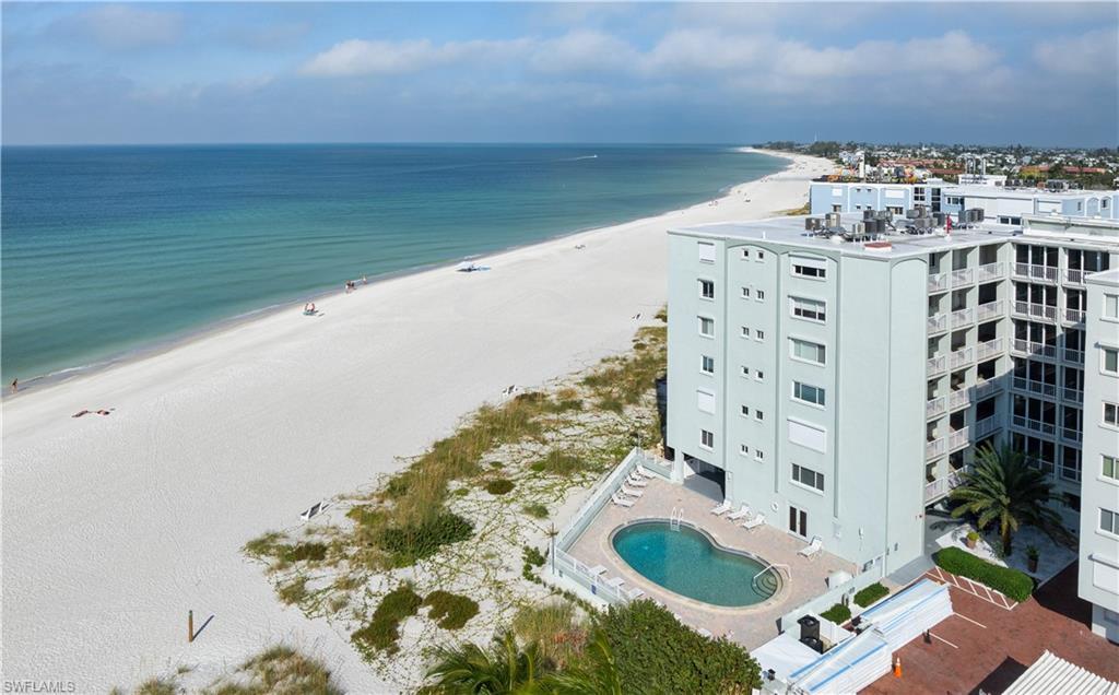 Image 2: Aerial view of unending shoreline and a pool