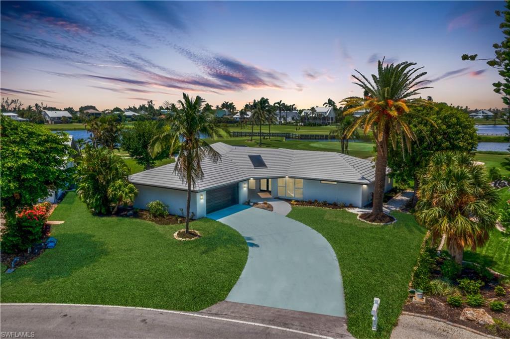 Image 3: Aerial view of the home at dusk!