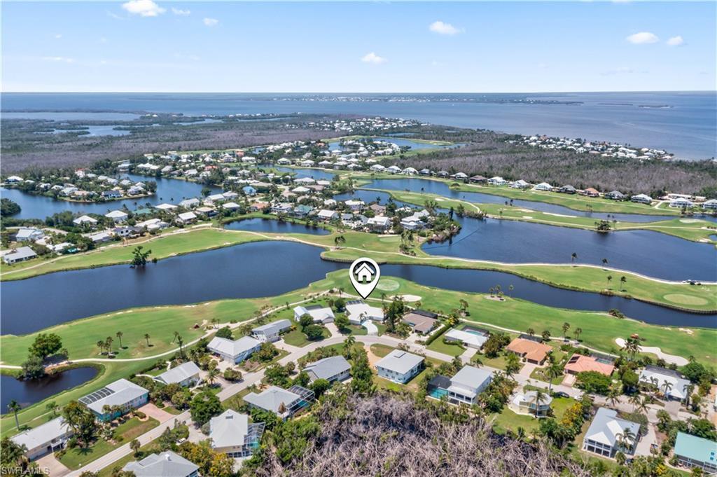 Image 4: LOCATION LOCATION LOCATION!  Beautiful aerial view of the home and the surrounding golf course and in the distance the blue waters of the Gulf of Mexico!