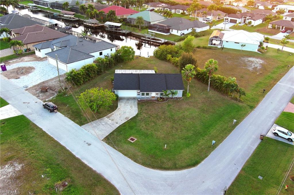Image 3: Aerial perspective of suburban area featuring a large body of water