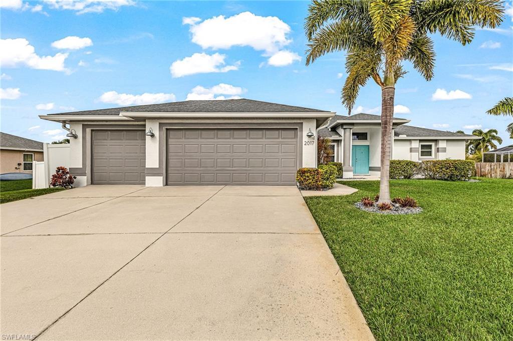 Image 1: Prairie-style home with a 3 car garage, stucco siding, driveway, and roof with shingles