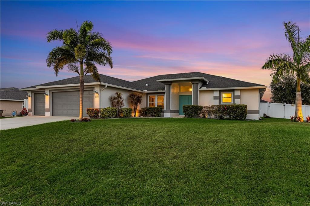 Image 4: House at dusk with exterior landscape lights