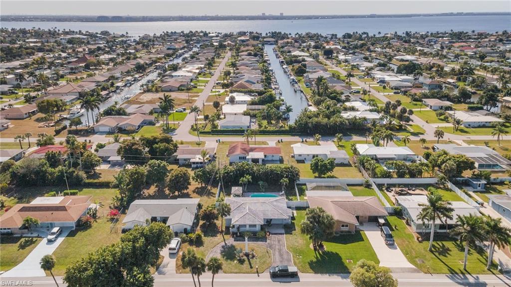 Image 3: View of property location with nearby suburban area and a large body of water