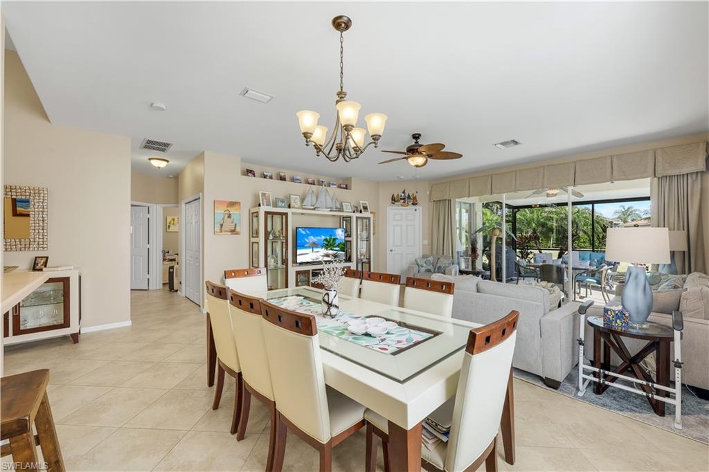 Image 1: Dining room featuring light tile patterned flooring, a chandelier, and ceiling fan