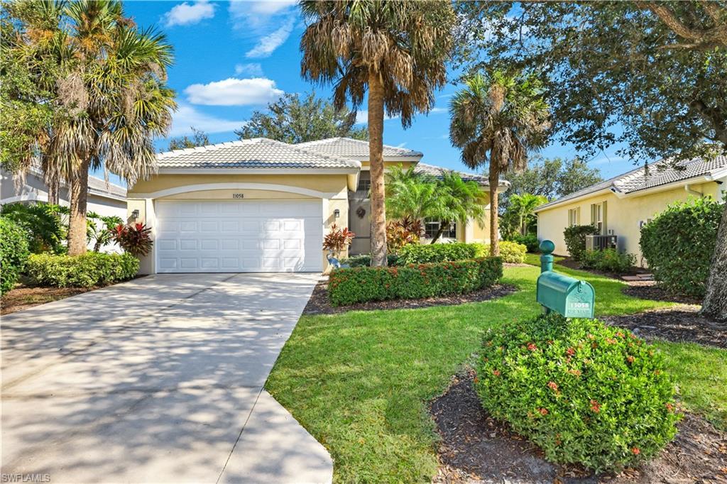 Image 2: Single story home featuring stucco siding, concrete driveway, an attached garage, a tile roof, and a front lawn