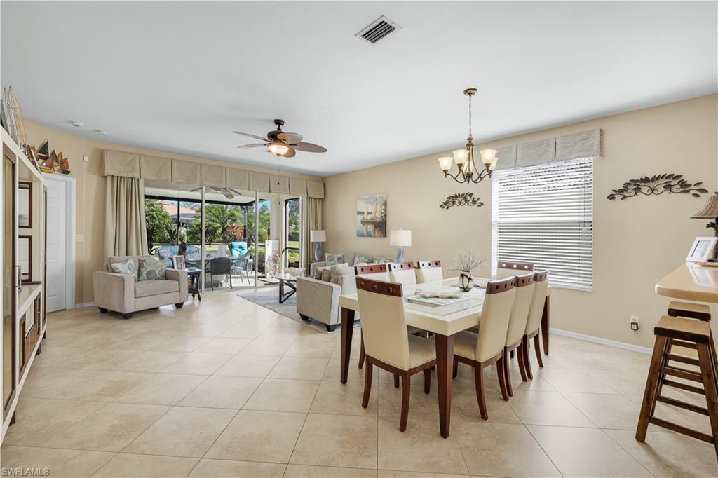Image 4: Dining room featuring ceiling fan, light tile patterned floors, and a chandelier