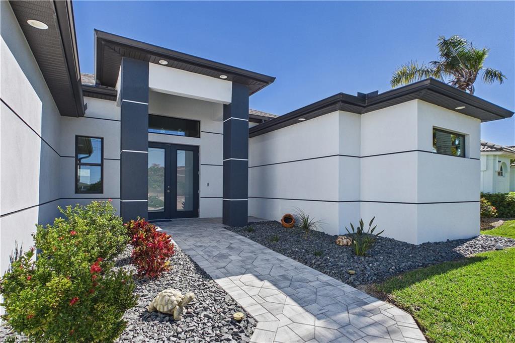 Image 2: View of exterior entry featuring french doors and stucco siding