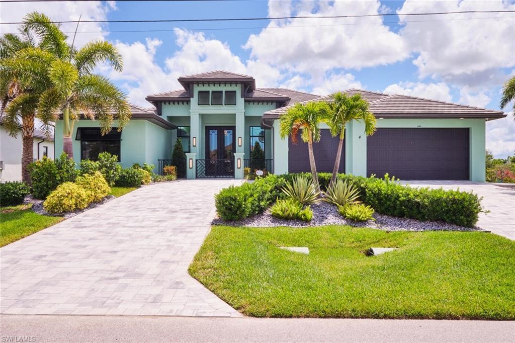 Image 3: Mediterranean / spanish-style house with decorative driveway, stucco siding, a front yard, and an attached garage