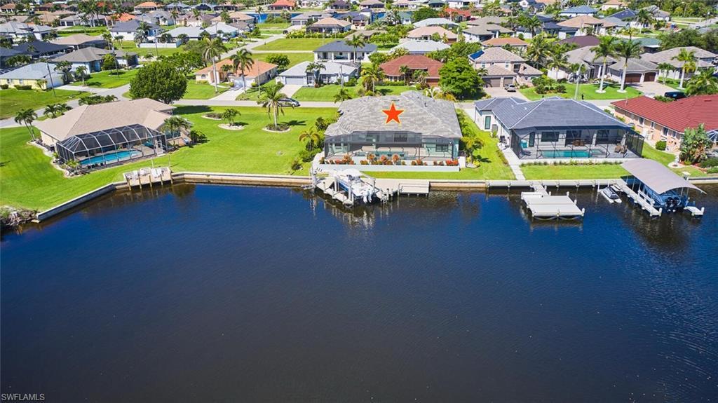 Image 4: Aerial perspective of suburban area with a large body of water